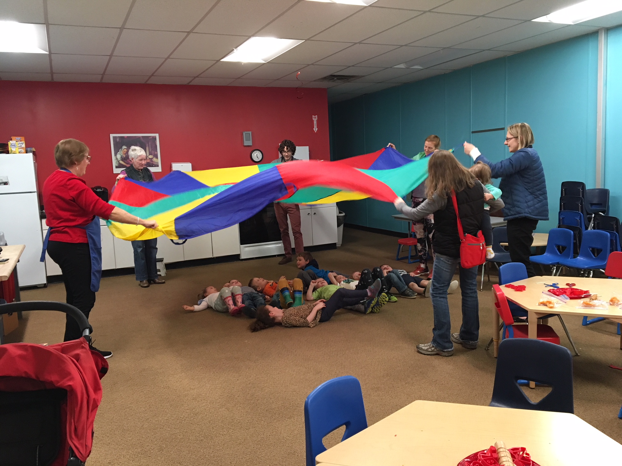 Children playing beneath parachute