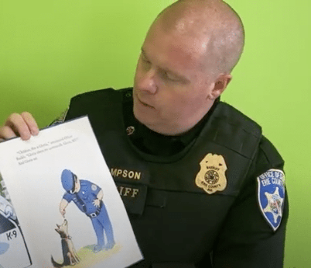 Trucking through the Summer A-Z Storytime:  Sheriff Thompson from the Buffalo Sheriff K-9 Unit reads Officer Buckle and Gloria